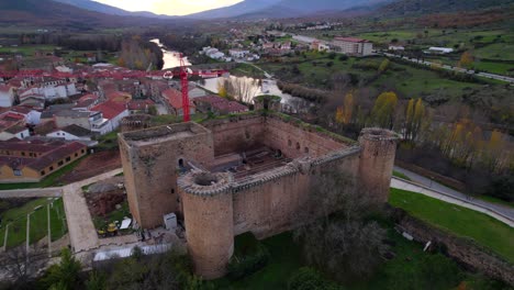 Aerial-Flying-Over-Towards-Courtyard-Of-Castillo-de-Valdecorneja-Going-Through-Restorations-With-Red-Construction-Crane-In-View