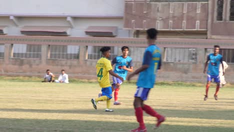 Football-Player-Kicking-Ball-In-Local-Team-Match-In-Karachi,-Pakistan