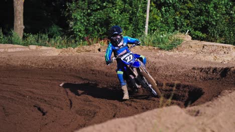 Dirt-Bike-Race-member-in-blue-coming-from-around-the-curve