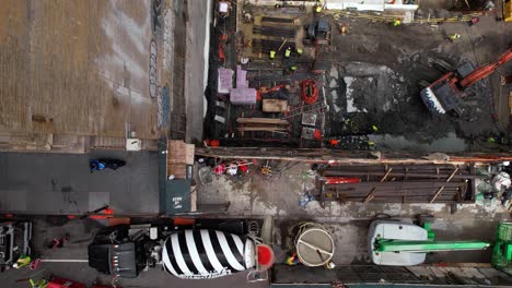 Aerial-view-above-a-mixer-truck-at-a-construction-site-in-NYC---cenital,-drone-shot