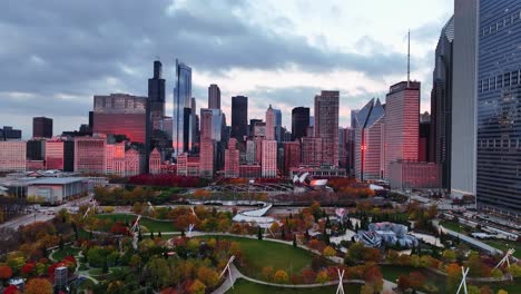Aerial-view-of-sunlit-high-rise-and-the-Millenium-park,-fall-sunrise-in-Chicago,-USA