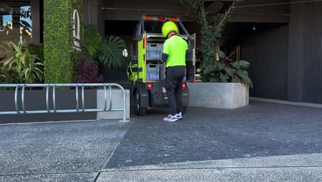 Postie-delivering-mails-and-parcels-in-the-latest-battery-operated-electric-vehicle,-Australia-Post-combatting-climate-change,-reducing-environmental-impact,-Brisbane-city,-Queensland