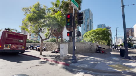 Driving-by-homeless-persons-living-on-the-streets-of-San-Diego,-California