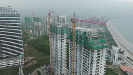 Suspended-construction-works-of-residential-seaside-multistory-buildings-in-Huizhou,-Guangdong,-China