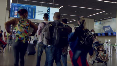 travelers-walking-through-brasilia-international-airport-with-their-luggage
