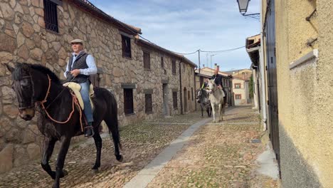 Horse-riders-in-rural-village-close-to-Avila,-Spain