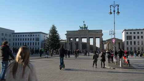 People-Walking-And-Riding-Stand-up-Electric-Scooters-At-The-Pariser-Platz,-Near-Brandenburg-Gate,-In-Berlin,-Germany