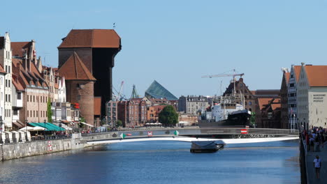 Historic-Port-Crane-and-Bridge-Moving-in-Position-over-the-River-Motława-in-Gdansk,-Poland