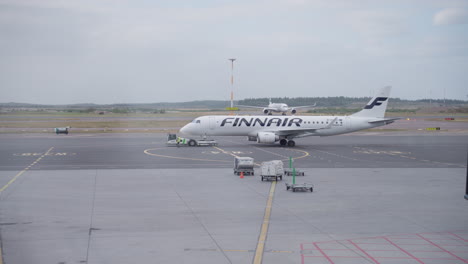Aerial-shot-of-Finnair-airplane-ready-to-take-off-in-the-airport-with-passengers-loaded-up