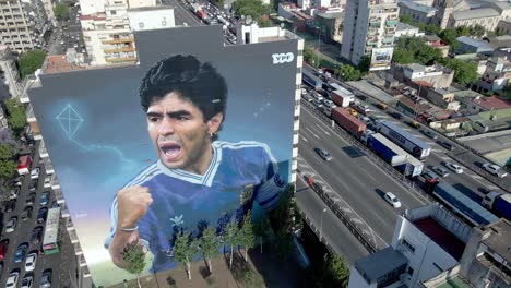 High-angle-aerial-view-capturing-late-soccer-superstar-Diego-Maradona-appeared-in-downtown-Buenos-Aires,-wall-mural-painted-by-Martin-Ron-dedicated-to-hand-of-god-on-his-second-anniversary-of-death