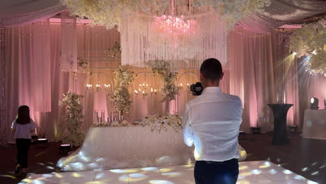A-videographer-captures-a-beautifully-decorated-wedding-table-at-a-wedding-expo