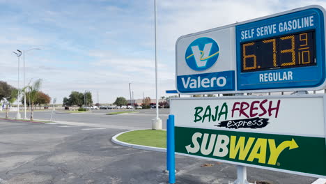Camera-panning-from-electronic-signboard-with-prices-to-Valero-gas-station