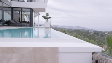Low-Angle-View-Across-Infinity-Pool-At-Hilltop-Luxury-Home-Overlooking-Calp-In-Spain