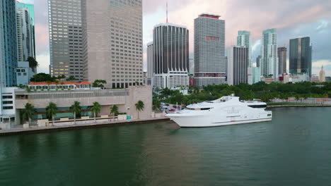 Drone-flying-above-the-water-surface-and-over-the-white-mega-yacht-moored-in-Biscayne-bay