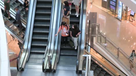 Retail-shoppers-ride-on-automatic-moving-escalators-at-a-shopping-mall-in-Hong-Kong