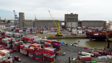 Aerial-pan-of-trucks-and-cargo-containers-at-industry-port,-Argentina