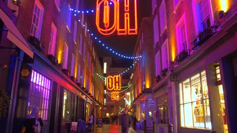 Colorful-Neon-Lights-Above-The-Street-On-A-Christmas-Night-In-The-Entertainment-District-Of-Soho-In-London,-UK