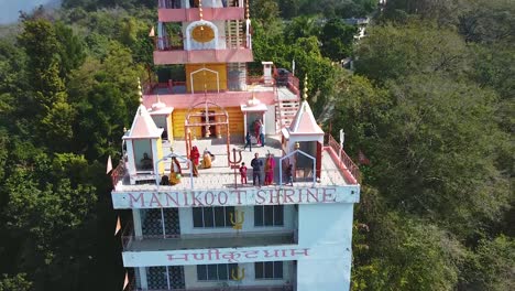 isolate-multistory-hindu-temple-in-the-middle-of-the-forests-from-different-angle-aerial-shot-video-is-taken-at-bhutnath-temple-rishikesh-uttrakhand-india-on-Mar-15-2022
