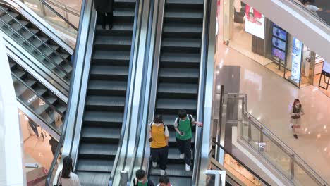 Chinese-retail-shoppers-ride-on-automatic-moving-escalators-at-a-high-end-shopping-mall-in-Hong-Kong