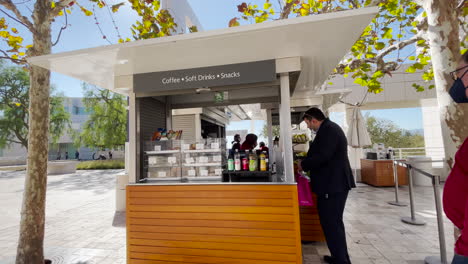 Customer-purchase-refreshments-at-a-coffee-cart-at-the-Getty-Museum,-Los-Angeles