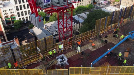 Aerial-view-of-people-working-on-top-of-a-construction-site-on-top-of-the-Alloy-Block,-in-Brooklyn,-USA