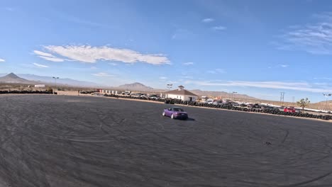 Performance-car-on-a-skid-pad-at-the-Apple-Valley-Speedway---first-person-drone-view
