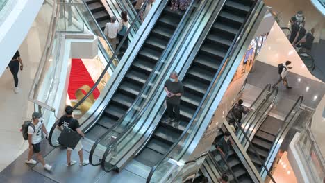 Retail-shoppers-ride-on-numerous-automatic-moving-escalators-at-a-high-end-shopping-mall-in-Hong-Kong