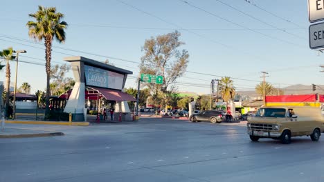Trucks-and-cars-drive-by-near-the-entrance-to-the-Sentri-Lane-in-Otay,-Tijuana,-Mexico