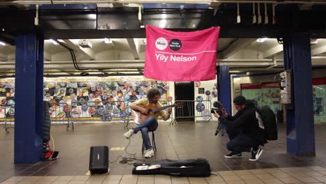 Content-Creator-Filming-Guitar-Busker-On-New-York-Metro-Subway-Platform