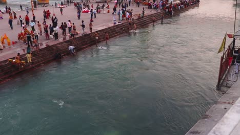 ganges-river-bank-with-devotee-crowed-at-evening-from-flat-angle-video-is-taken-at-har-ki-pauri-haridwar-uttrakhand-india-on-Mar-15-2022