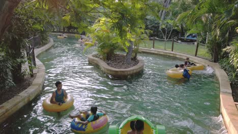 Families-flowing-on-river-like-public-pool-using-PVC-floating-boat