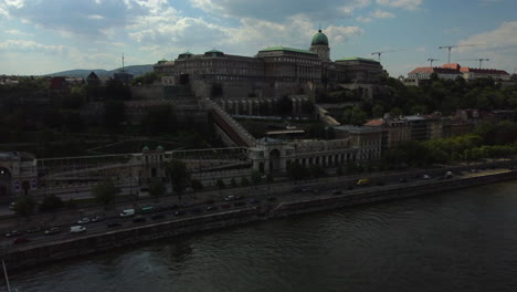 Tiro-De-Dron-Del-Palacio-Real-En-Budapest,-Hungría---Dron-Está-Volando-Alejándose,-Cruzando-El-Donau