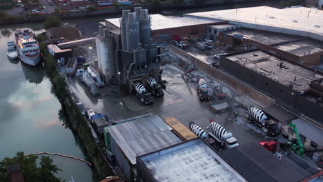 Drone-Shot-of-Concrete-Ready-Mix-Factory,-Facility,-Loading-Station-and-Heavy-Mixer-Trucks