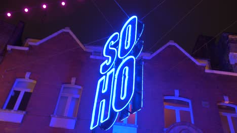 Soho-District-Illuminated-Neon-Light-Sign-In-Aesthetic-Blue-Along-The-Street-At-Night-In-London,-UK