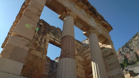 Columns-of-Treasury-of-Athenians-in-Delphi-Archaeological-Site-with-Blue-Sky-in-Background