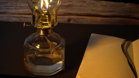 Old-hurricane-oil-lamp-and-an-open-book