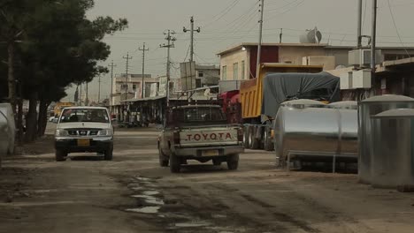 Cars-passing-by-in-side-street-in-Iraq