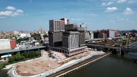 Aerial-view-in-front-of-the-Bronx-Point-building,-under-construction-in-NY,-USA---ascending,-drone-shot
