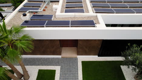 Aerial-View-Over-Walled-Garden-Entrance-To-Luxury-Home-With-Solar-Panels-In-Calp,-Spain