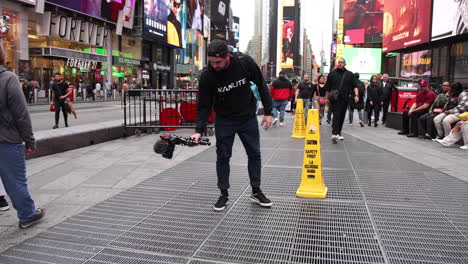 Filmemacher-Dan-Mac-Filmt-Gitteröffnungen-Auf-Dem-Time-Square-In-New-York