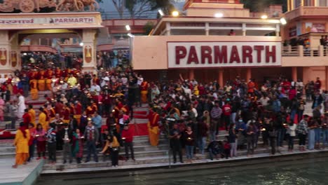 holy-ganges-river-evening-aarti-with-devotee-gathered-for-pryer-video-is-taken-at-parmarth-niketan-rishikesh-uttrakhand-india-on-Mar-15-2022