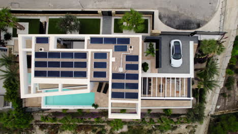 Aerial-Birds-Eye-View-Of-Solar-Panels-On-Rooftop-Of-Luxury-Home-On-Hilltop-In-Calp,-Spain