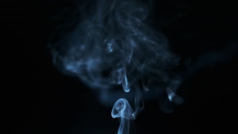 Smoke-floating-in-the-air-on-a-black-background