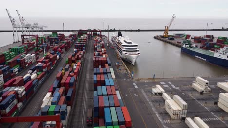 Freight-containers-and-cruise-ship-at-industry-port,-Argentina,-aerial
