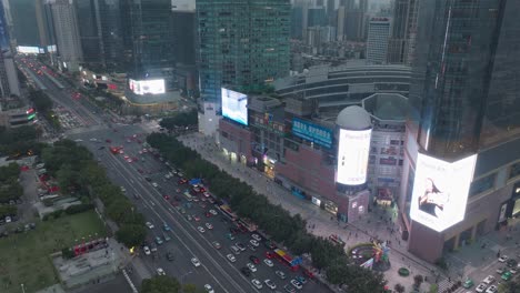 Downtown-street-of-Guangzhou-with-big-shopping-malls-and-dense-traffic-in-the-evening-after-pandemic-restrictions-lifted