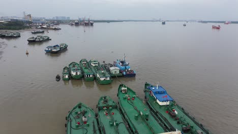 Aerial-view-of-shoreline-and-working-boats-on-Saigon-River-waterfront