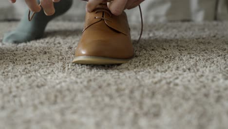 Groom-tying-his-shoes
