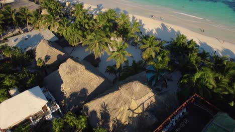 Aerial-view-over-a-resort-with-their-private-beach-in-Tulum,-Mexico