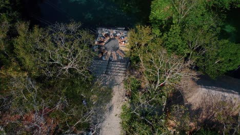 Top-down-aerial-view-over-people-doing-yoga-in-Cenote-Mayan-Tulum,-Mexico