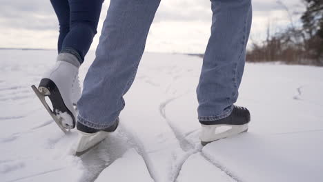 Couple-ice-skates-on-snowy-lake